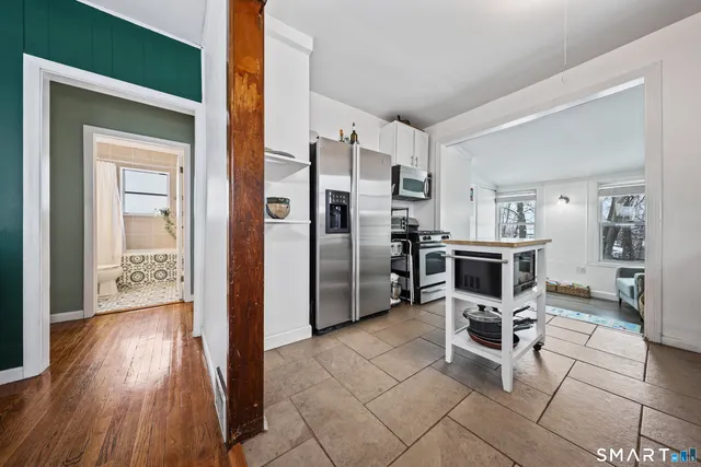 a kitchen with stainless steel appliances a refrigerator and microwave