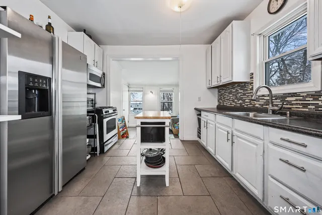 a kitchen with refrigerator and cabinets