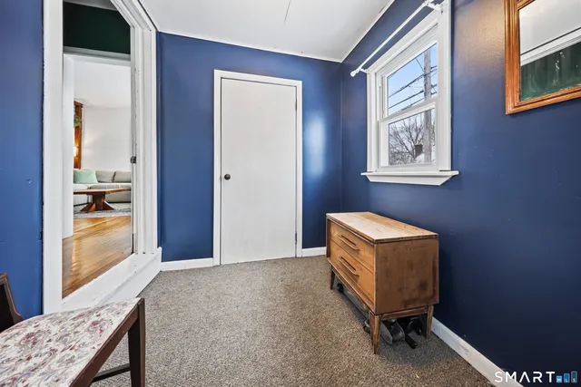 a room that has a chair and a dresser in it