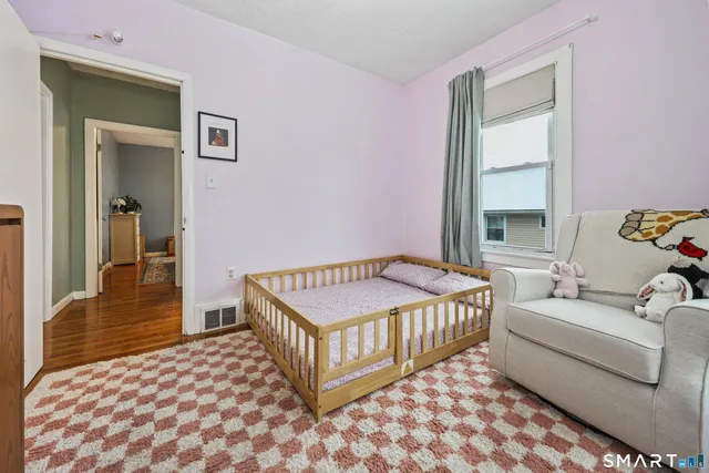 a bedroom with a bed and a window