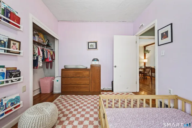a bedroom with furniture and baby crib