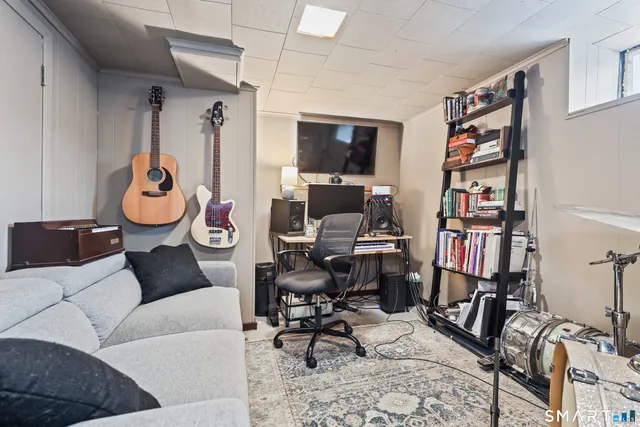 a living room with furniture a air conditioner vent and a window