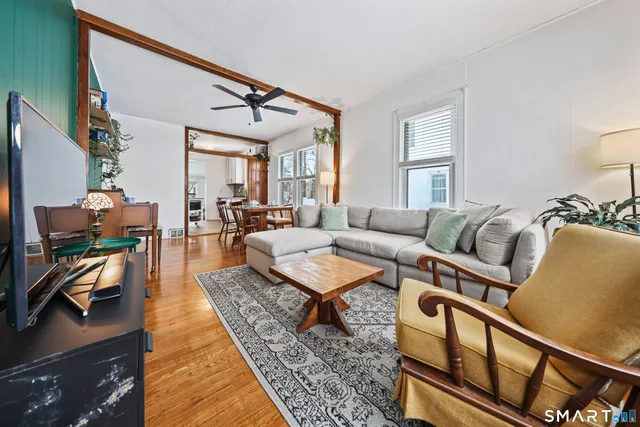 a living room with furniture a fireplace and a flat screen tv