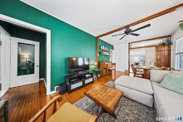 a living room with furniture and a flat screen tv