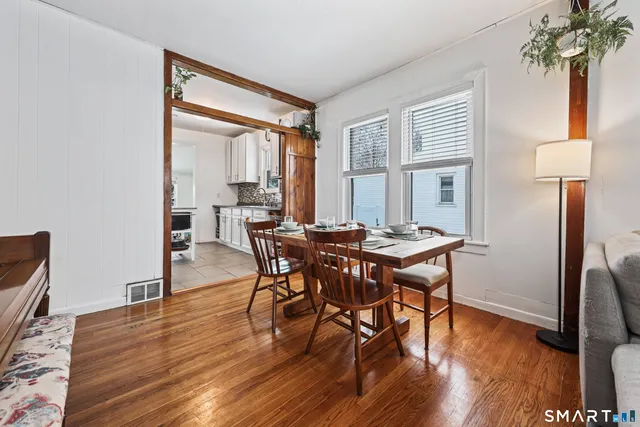 a view of a dining room with furniture and wooden floor