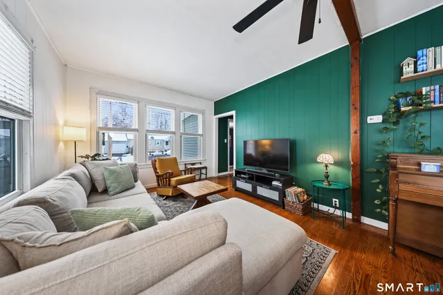 a living room with furniture and a flat screen tv