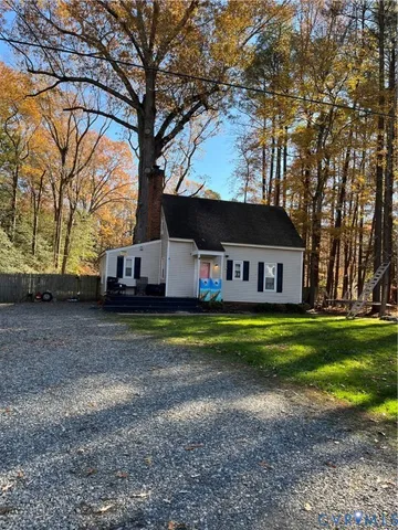 a front view of house with yard and trees