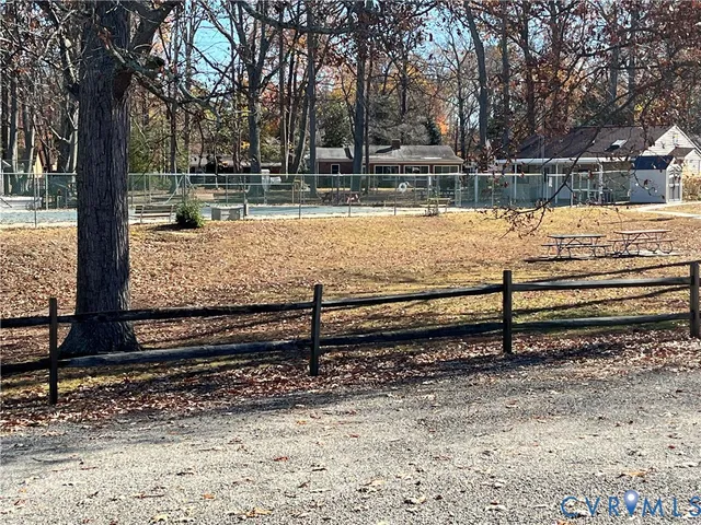 a view of a yard with wooden fence