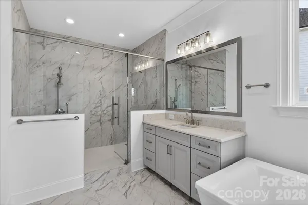 a bathroom with a double vanity sink mirror and shower
