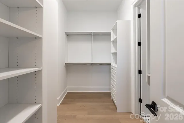 a view of walk in closet with empty racks
