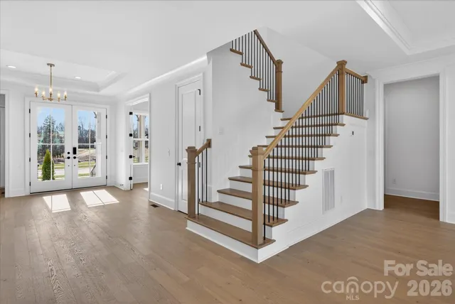 a view of entryway with wooden floor and stairs