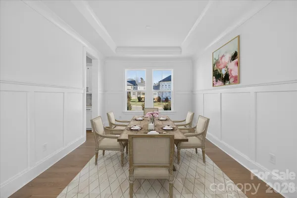 a dining room with furniture and wooden floor