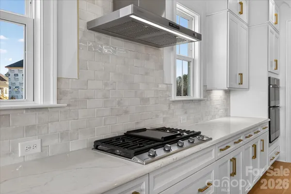 a kitchen with granite countertop a stove and a sink