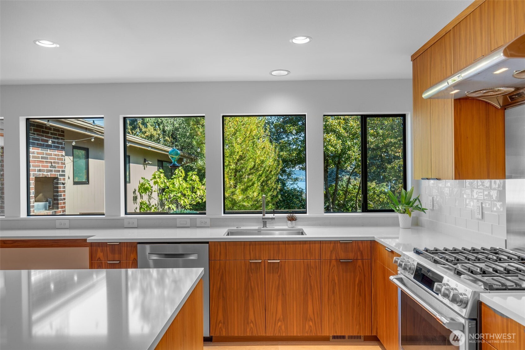 6667 Northeast Windermere Road Seattle, WA 98115 - Photo 11 of 40 a kitchen with stainless steel appliances a sink a stove and a refrigerator