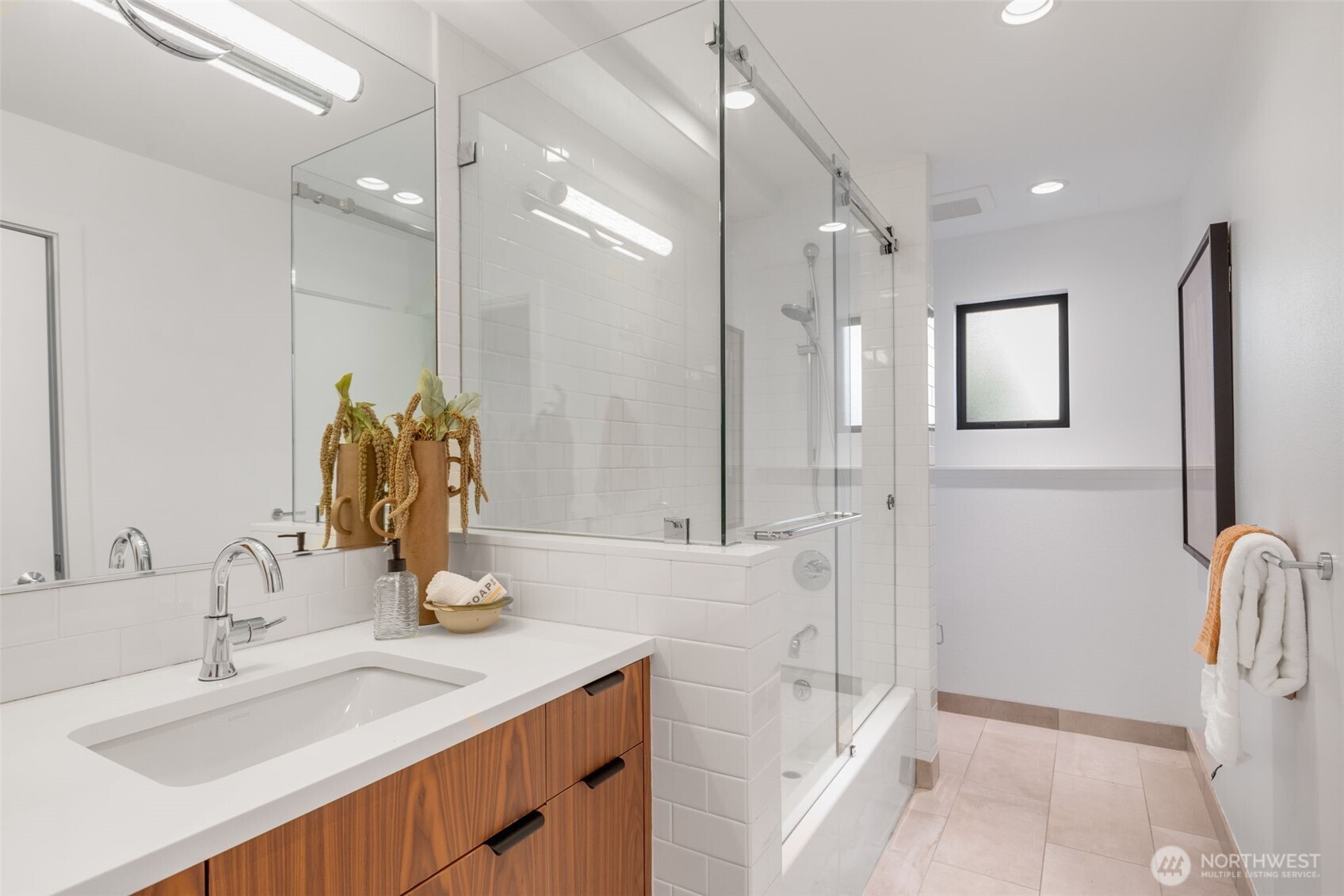 6667 Northeast Windermere Road Seattle, WA 98115 - Photo 28 of 40 a bathroom with a sink tub vanity and a mirror