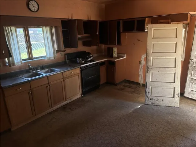 a kitchen with a refrigerator and a sink