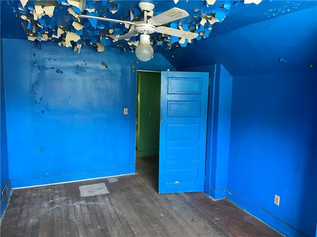 a view of an entryway with a flower pot and a bookshelf