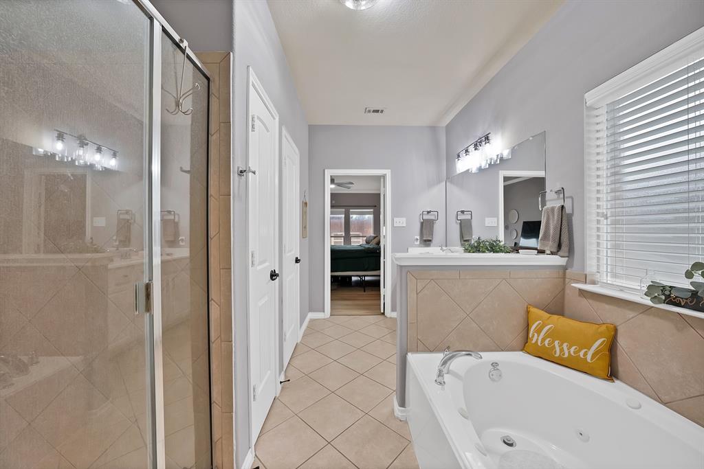 3822 Spring Run Lane Melissa, TX 75454 - Photo 23 of 39 a bathroom with a tub sink and mirror