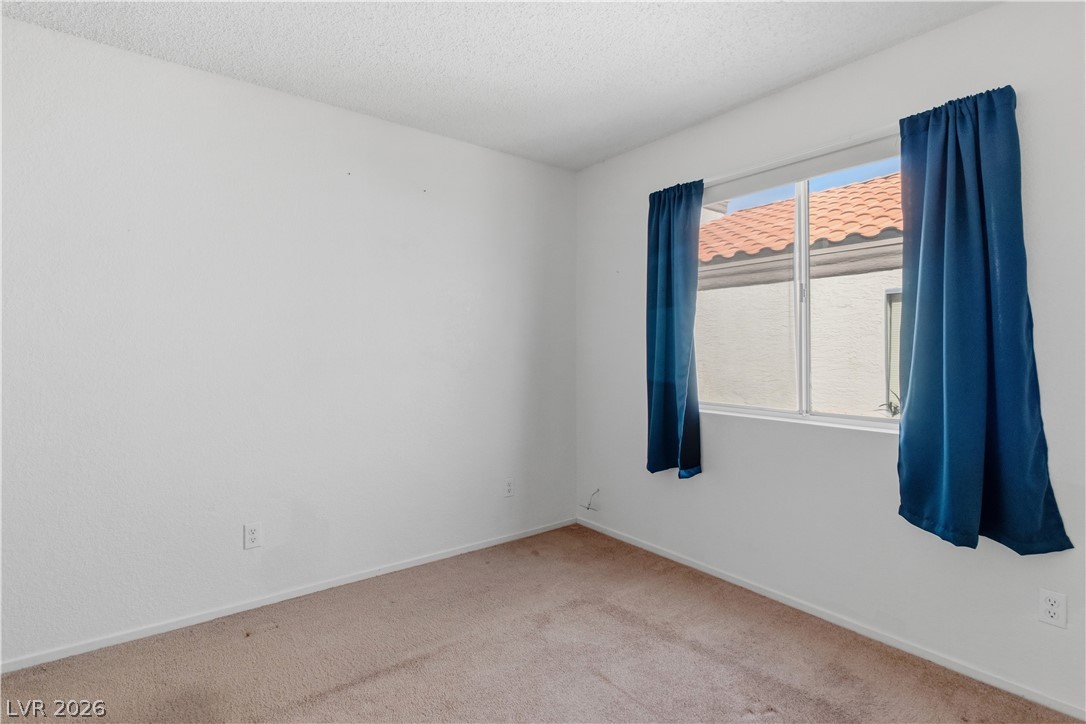 2124 Pebble Creek Lane Laughlin, NV 89029 - Photo 31 of 54 Carpeted Third bedroom with a textured ceiling and baseboards