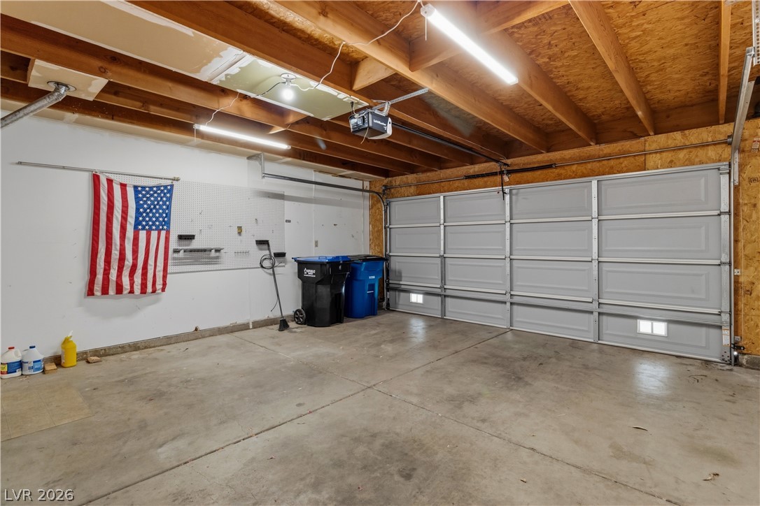 2124 Pebble Creek Lane Laughlin, NV 89029 - Photo 33 of 54 Garage featuring a garage door opener