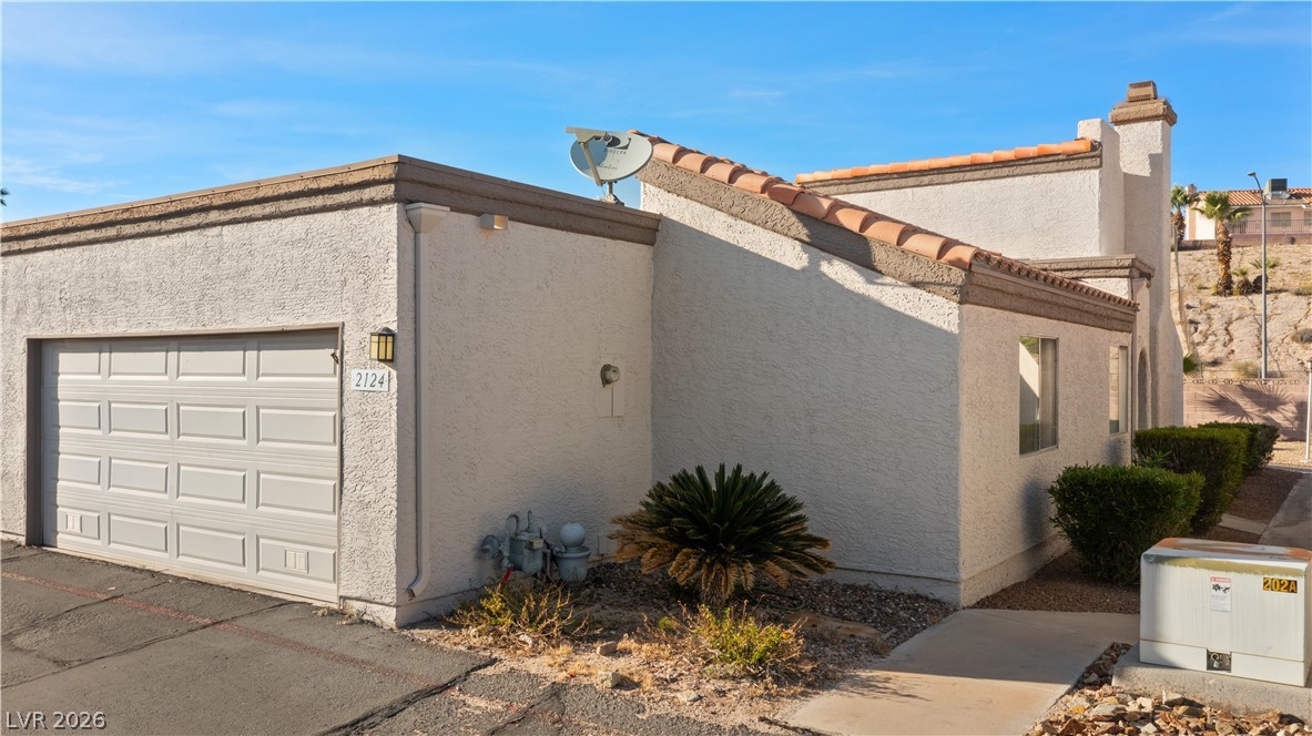 2124 Pebble Creek Lane Laughlin, NV 89029 - Photo 43 of 54 View of home's exterior with stucco siding and a garage