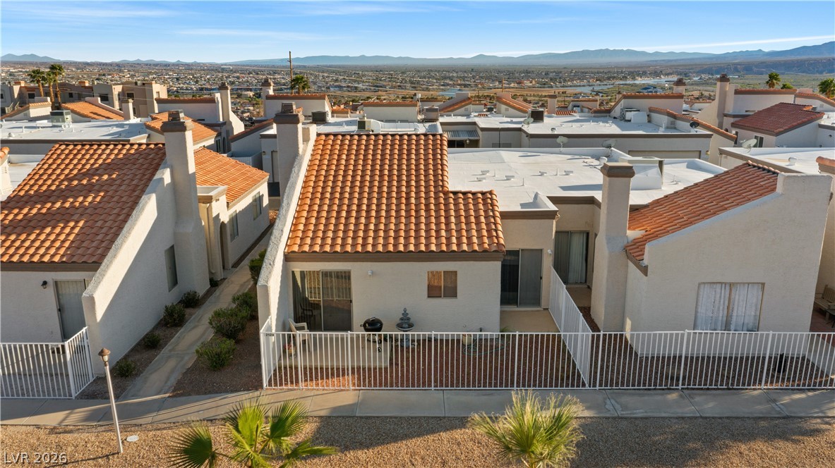 2124 Pebble Creek Lane Laughlin, NV 89029 - Photo 49 of 54 Back of property featuring stucco siding, a residential view, a chimney, and a mountain view