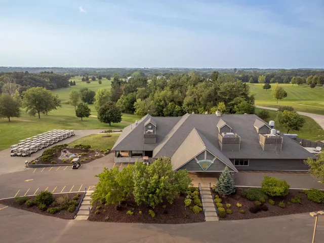 an aerial view of a house with big yard and large trees