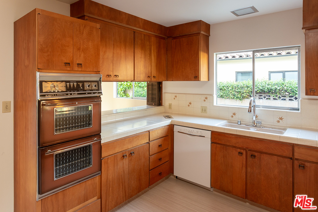 2116 Moreno Drive Los Angeles, CA 90039 - Photo 11 of 22 a kitchen with a sink stove and cabinets