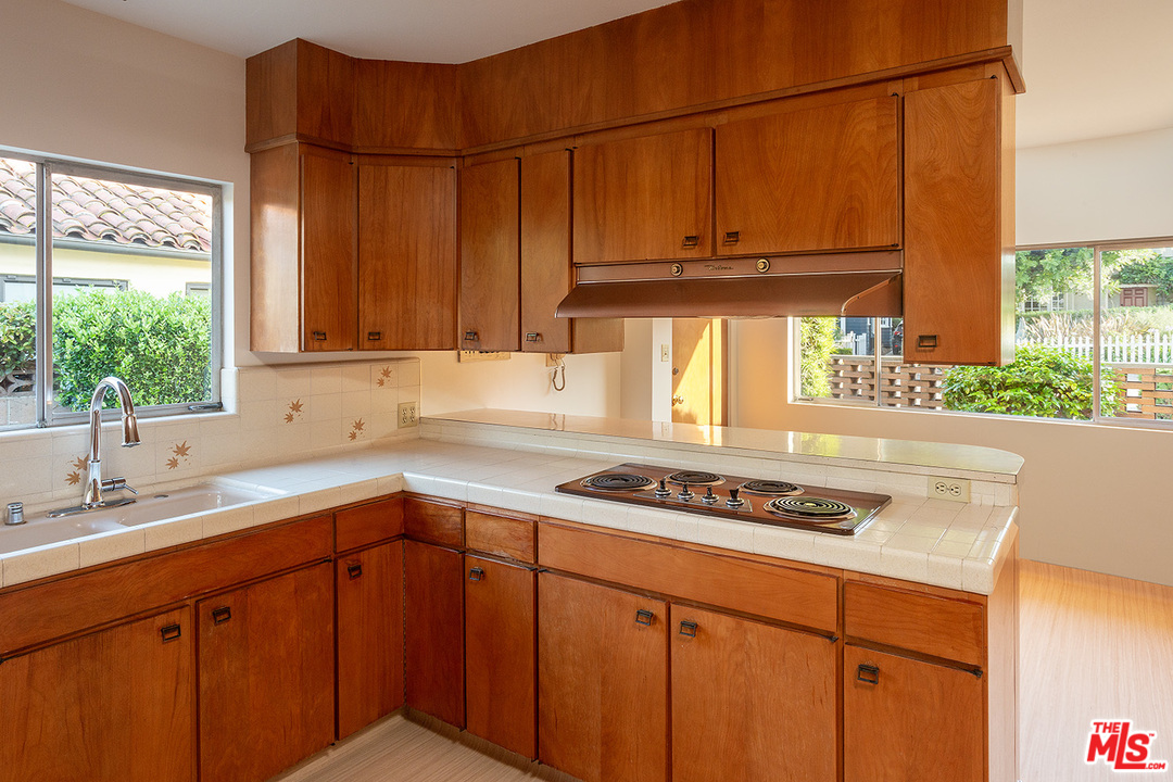 2116 Moreno Drive Los Angeles, CA 90039 - Photo 12 of 22 a kitchen with stainless steel appliances a sink a stove and window