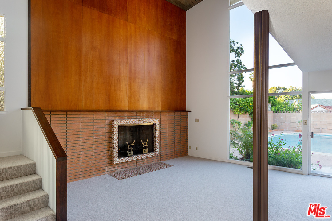 2116 Moreno Drive Los Angeles, CA 90039 - Photo 6 of 22 a view of empty room with fireplace and wooden floor