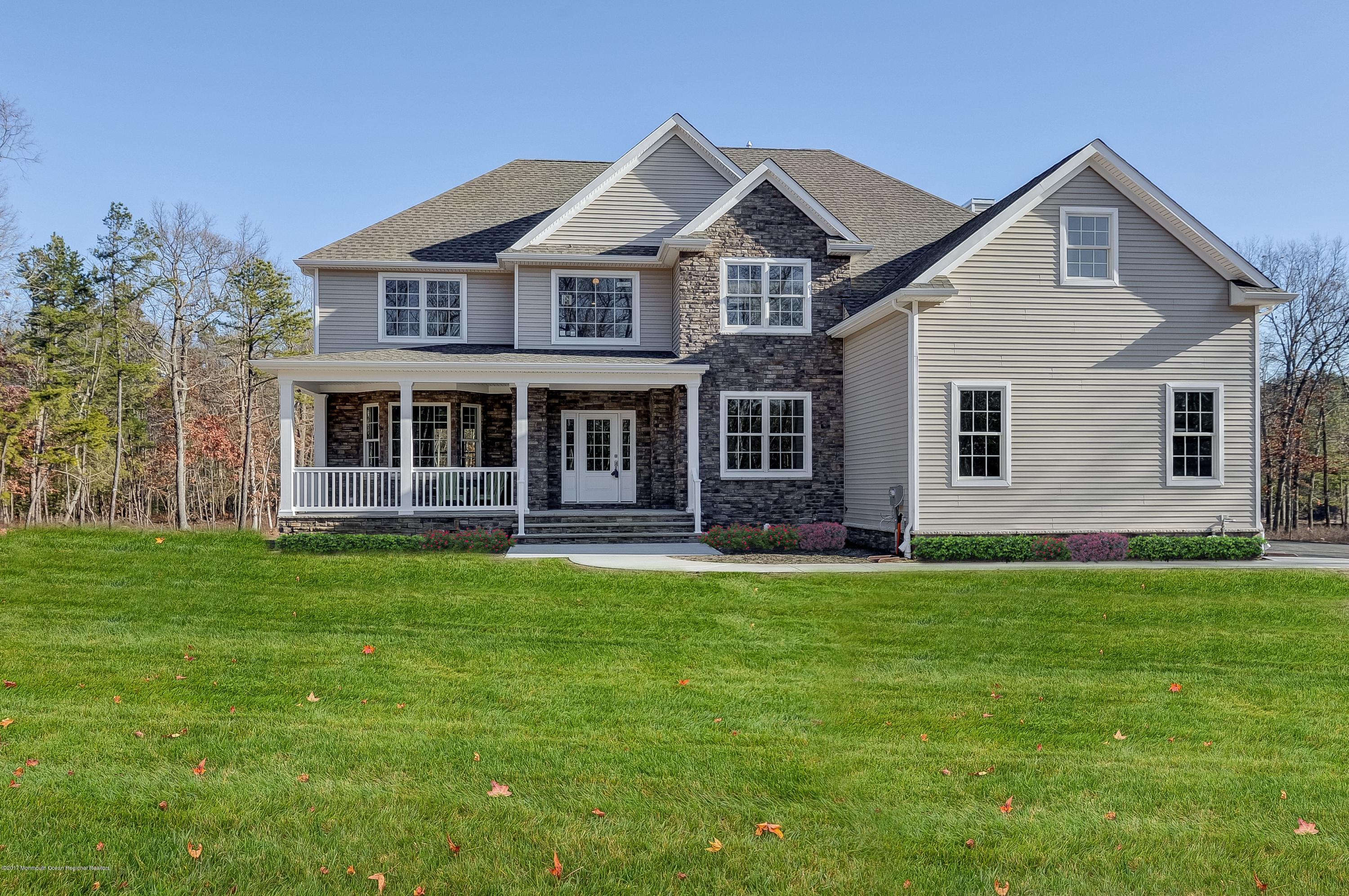 91 Obre Road Colts Neck, NJ 07722 - Photo 1 of 33 a front view of a house with a garden