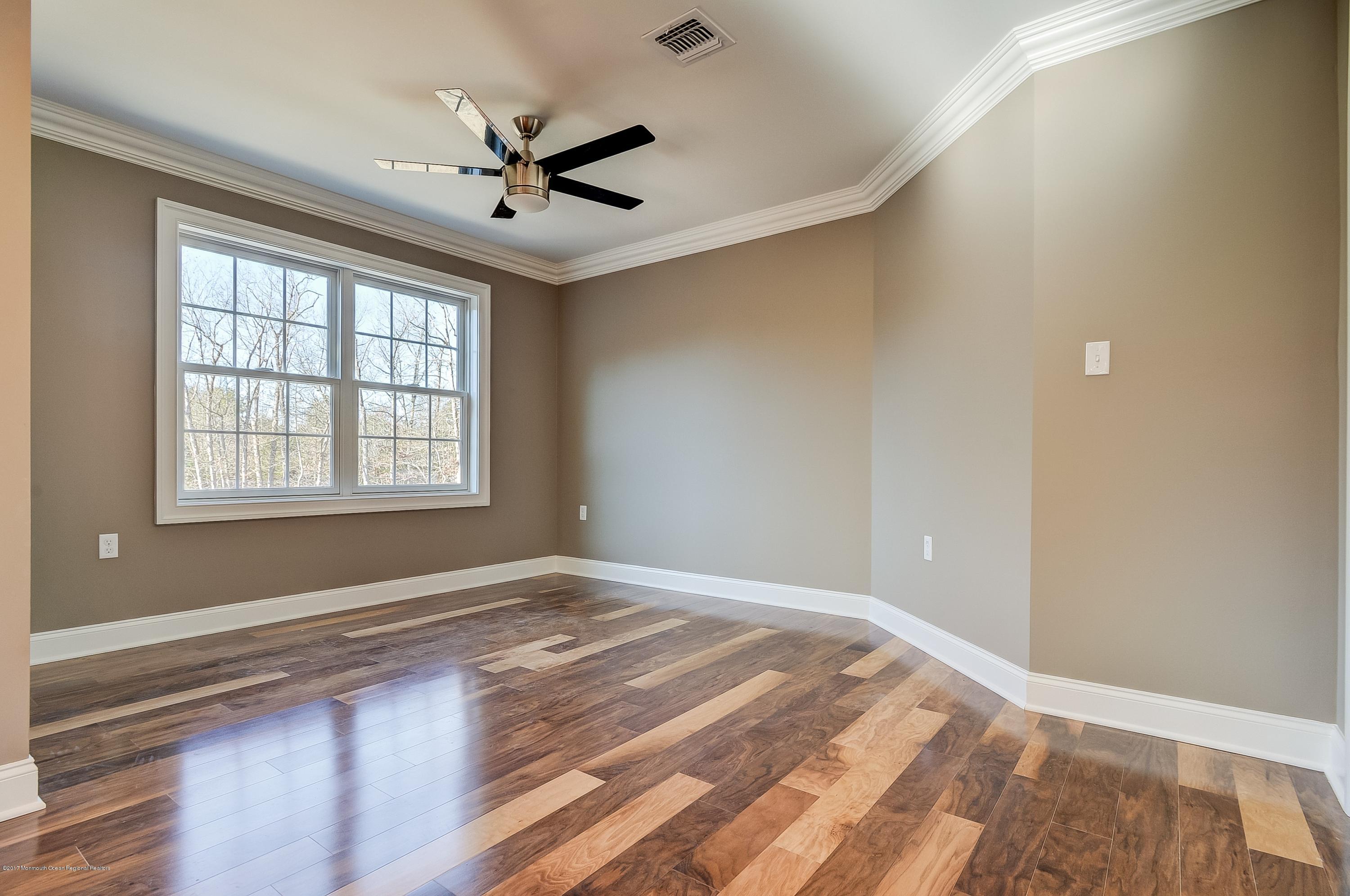 91 Obre Road Colts Neck, NJ 07722 - Photo 19 of 33 a view of a livingroom with a ceiling fan and window