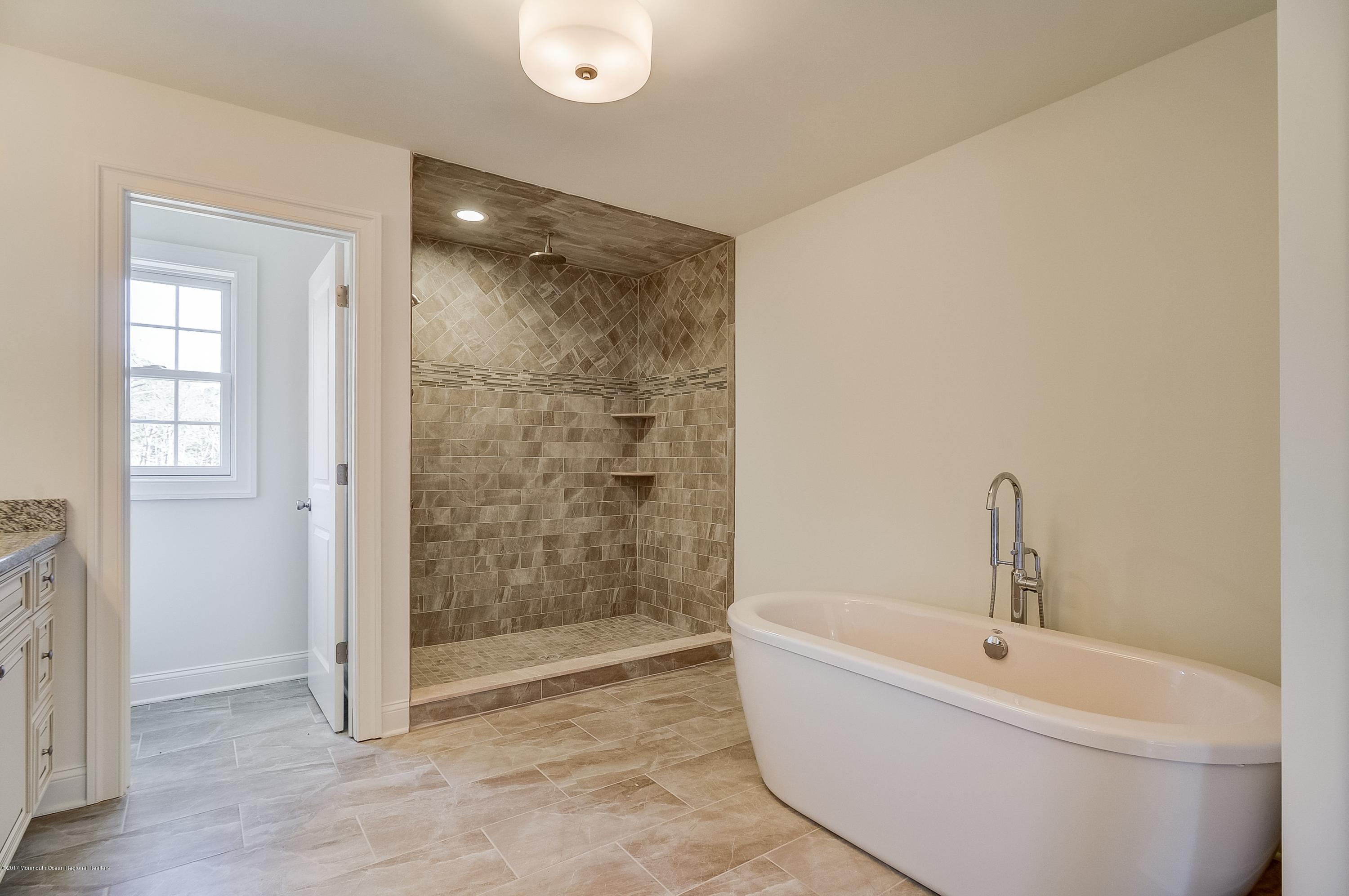 91 Obre Road Colts Neck, NJ 07722 - Photo 22 of 33 a bathroom with a bathtub and shower