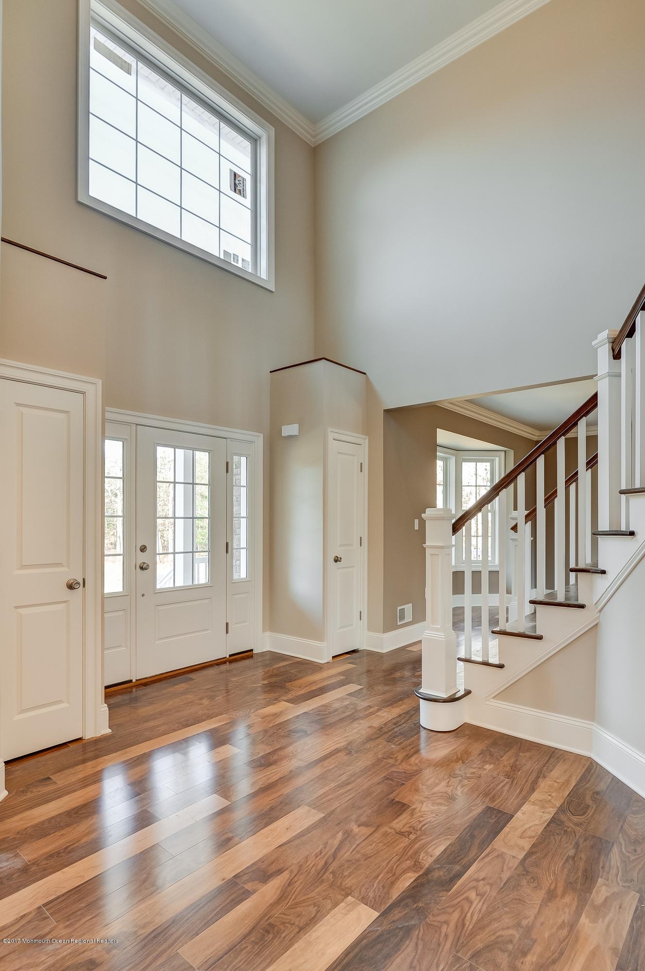 91 Obre Road Colts Neck, NJ 07722 - Photo 3 of 33 a view of an empty room with wooden floor and a window