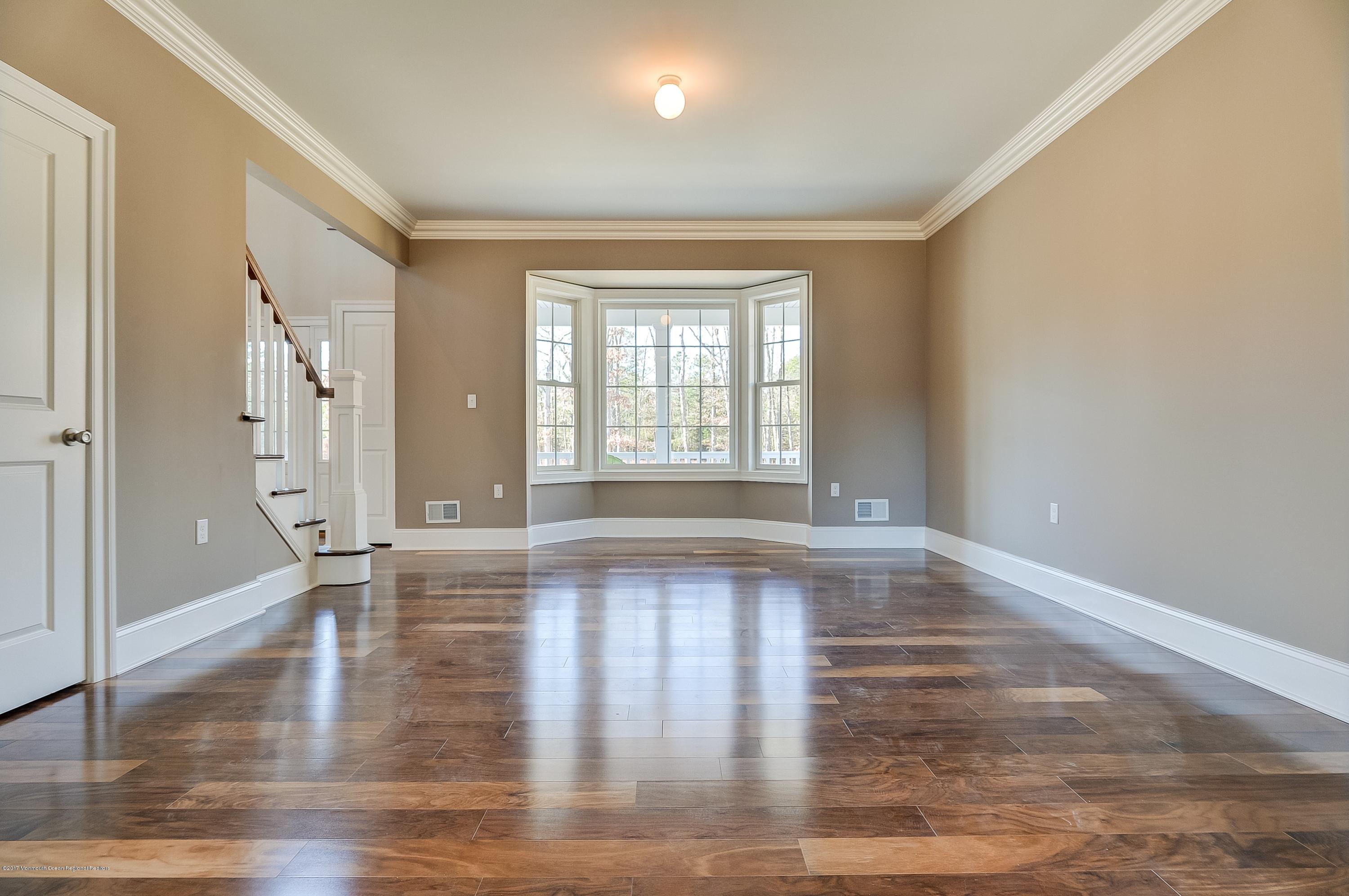 91 Obre Road Colts Neck, NJ 07722 - Photo 5 of 33 a view of an empty room with wooden floor and a window