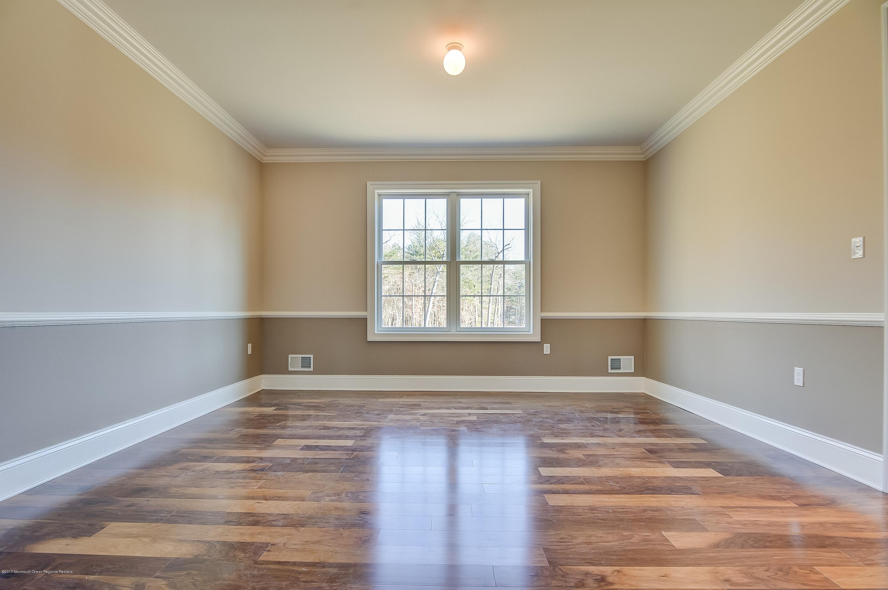 91 Obre Road Colts Neck, NJ 07722 - Photo 6 of 33 a view of an empty room with wooden floor and a window