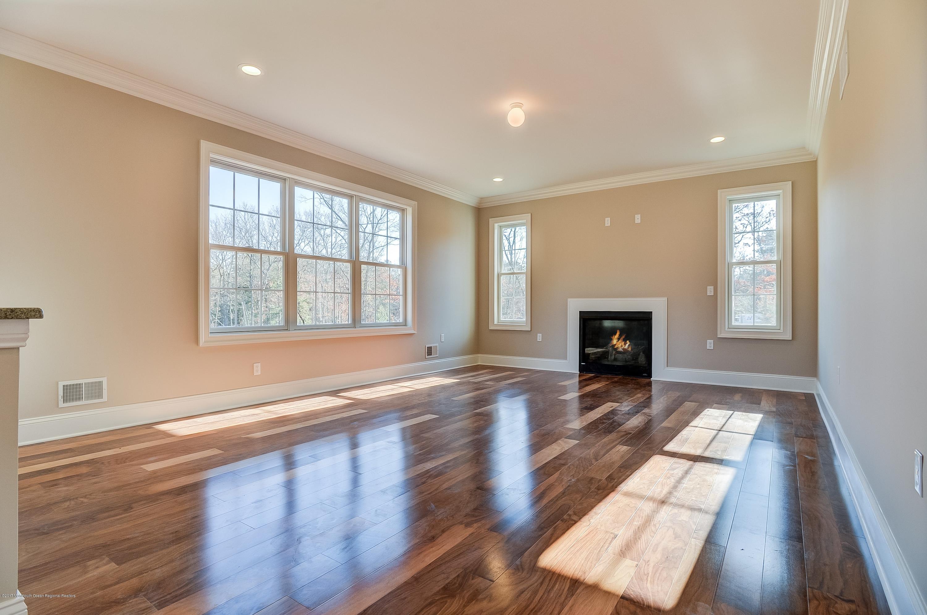 91 Obre Road Colts Neck, NJ 07722 - Photo 8 of 33 an empty room with windows and fireplace