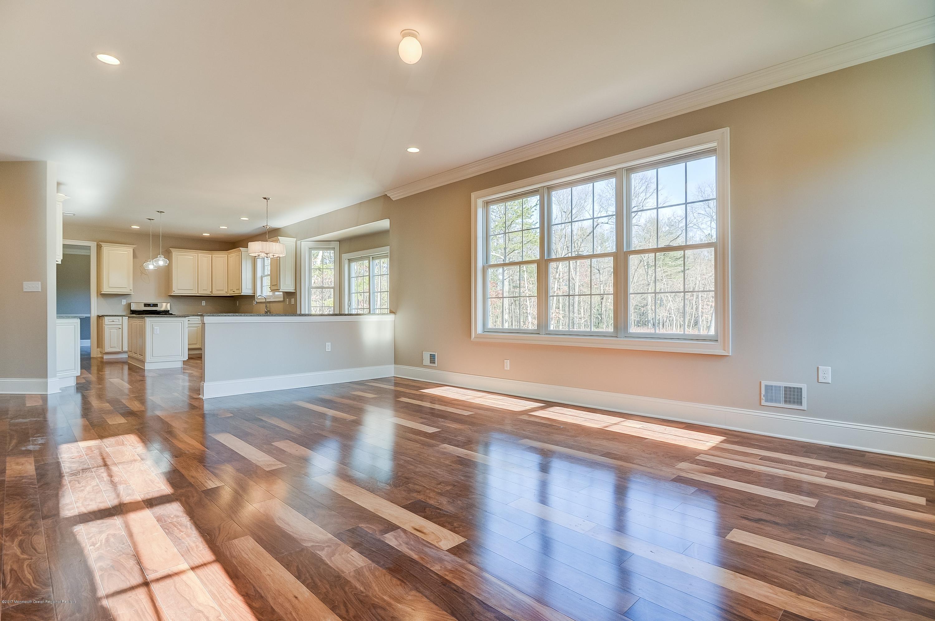 91 Obre Road Colts Neck, NJ 07722 - Photo 9 of 33 a view of empty room with wooden floor and windows
