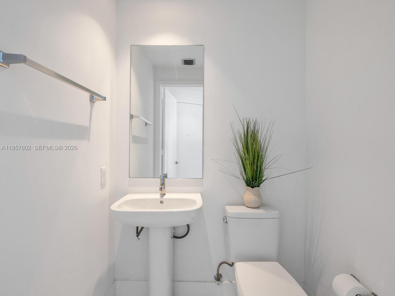 2900 Northeast 7th Avenue, Unit 3301 Miami, FL 33137 - Photo 24 of 55 a bathroom with a toilet a sink and a mirror