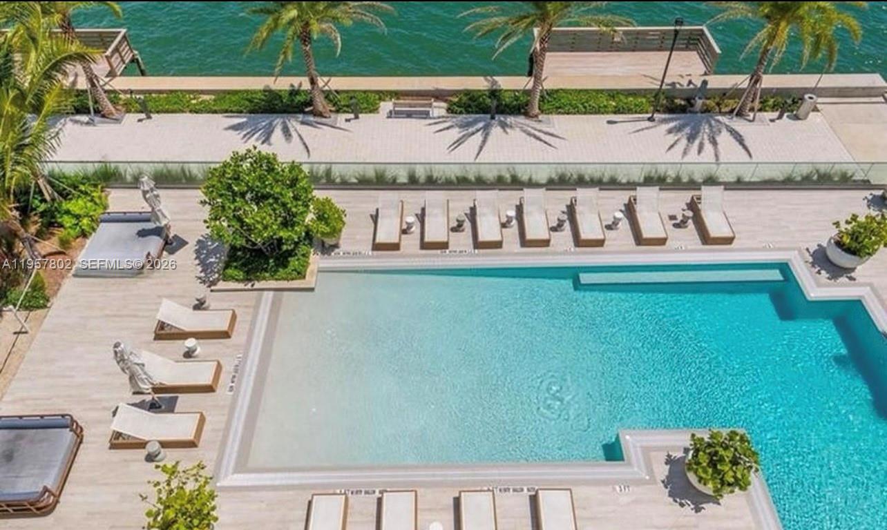 2900 Northeast 7th Avenue, Unit 3301 Miami, FL 33137 - Photo 45 of 55 a view of a swimming pool with a table and chairs under an umbrella