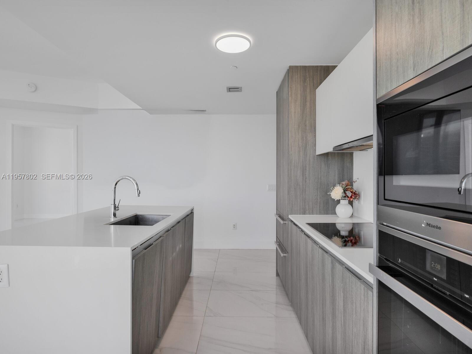 2900 Northeast 7th Avenue, Unit 3301 Miami, FL 33137 - Photo 10 of 55 a kitchen with stainless steel appliances granite countertop a sink and a stove