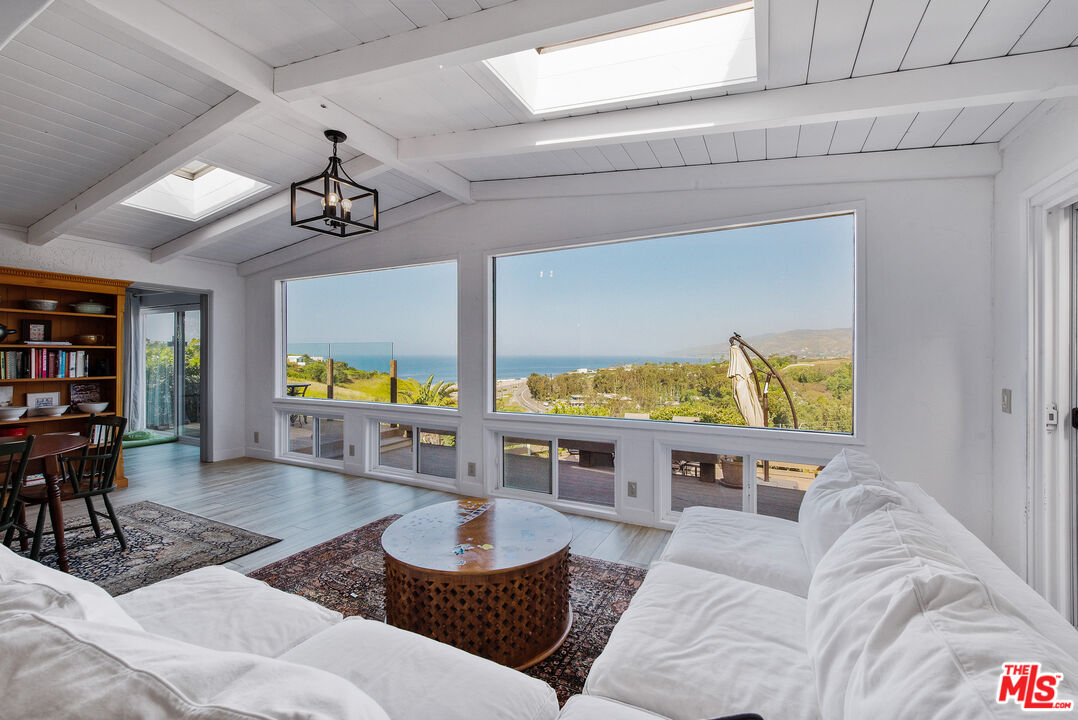 29500 Heathercliff Road, Unit 202 Malibu, CA 90265 - Photo 12 of 36 a living room with furniture and a large window