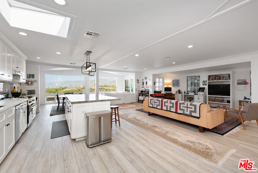 29500 Heathercliff Road, Unit 202 Malibu, CA 90265 - Photo 14 of 36 a large white dining hall with stainless steel appliances granite countertop a large kitchen counter top and stainless steel appliances