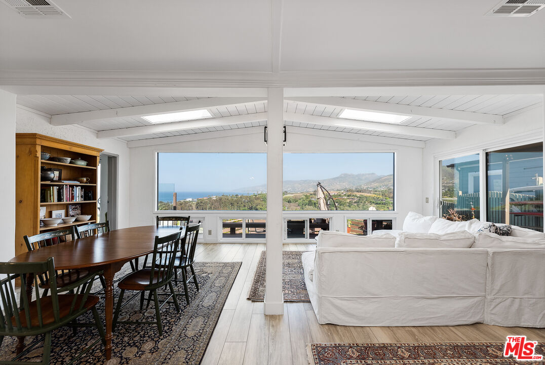 29500 Heathercliff Road, Unit 202 Malibu, CA 90265 - Photo 16 of 36 a living room with furniture and large windows