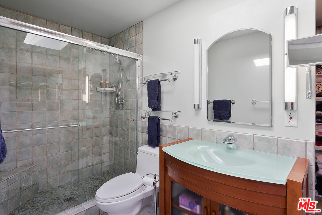 29500 Heathercliff Road, Unit 202 Malibu, CA 90265 - Photo 21 of 36 a bathroom with a sink toilet a mirror and shower