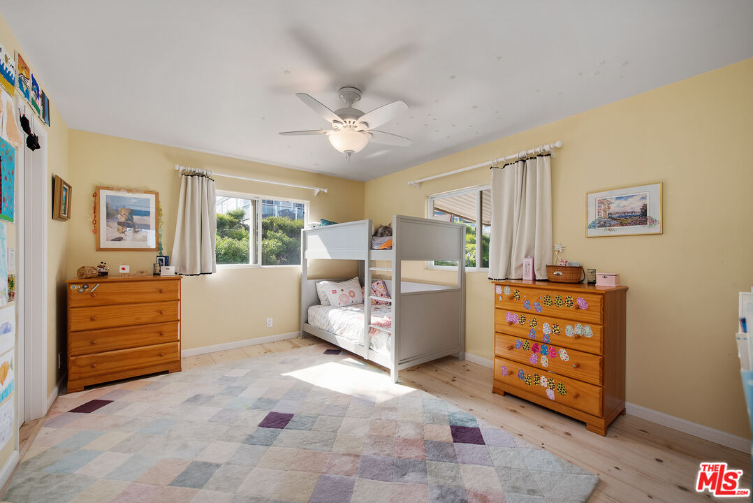 29500 Heathercliff Road, Unit 202 Malibu, CA 90265 - Photo 22 of 36 a bed room with furniture and a window