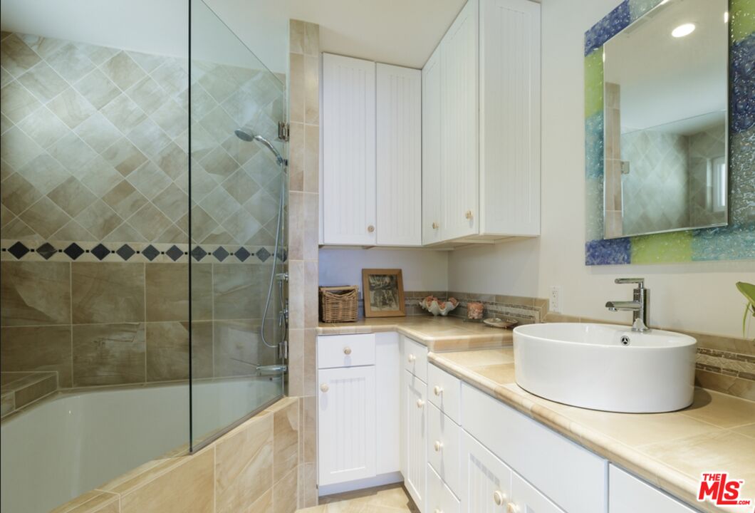 29500 Heathercliff Road, Unit 202 Malibu, CA 90265 - Photo 23 of 36 a bathroom with a sink and a mirror