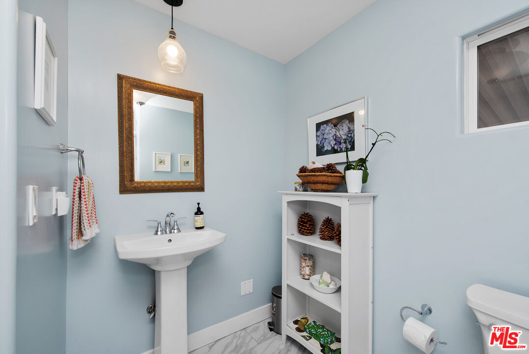 29500 Heathercliff Road, Unit 202 Malibu, CA 90265 - Photo 25 of 36 a bathroom with a sink and a mirror