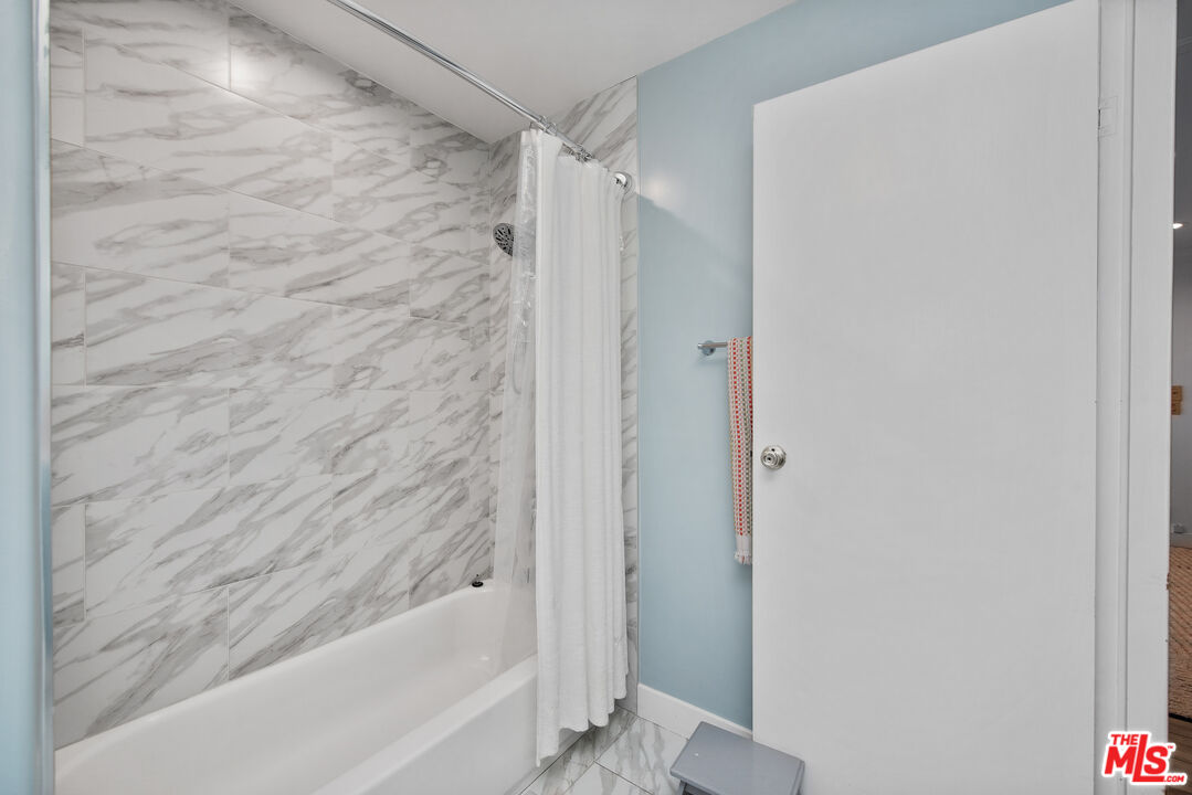 29500 Heathercliff Road, Unit 202 Malibu, CA 90265 - Photo 26 of 36 a bathroom with a bathtub and a shower