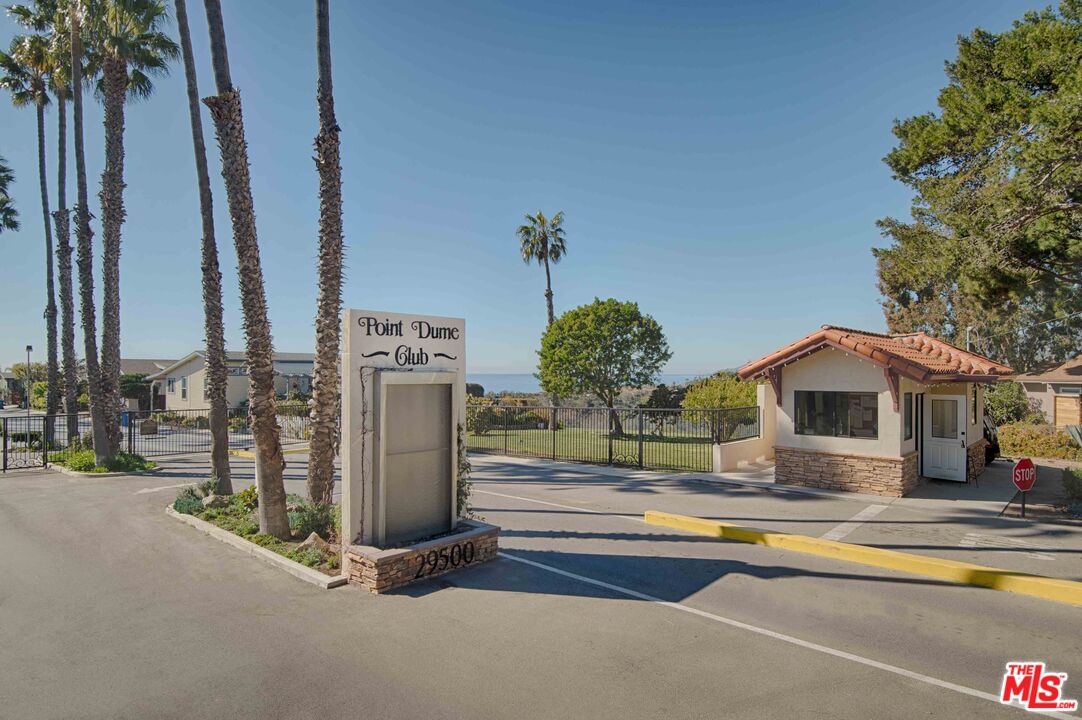 29500 Heathercliff Road, Unit 202 Malibu, CA 90265 - Photo 36 of 36 a view of a house with floor to ceiling windows and a basket ball poll